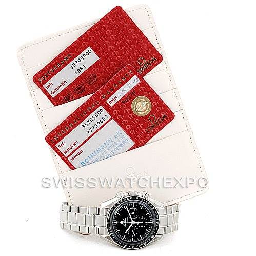 The image shows an Omega Speedmaster 3570.50.00 Men
s Stainless Steel Black Dial 3570.50.00 Men
s Stainless Steel Black Dial watch from a top-down angle, accompanied by warranty and certification cards.