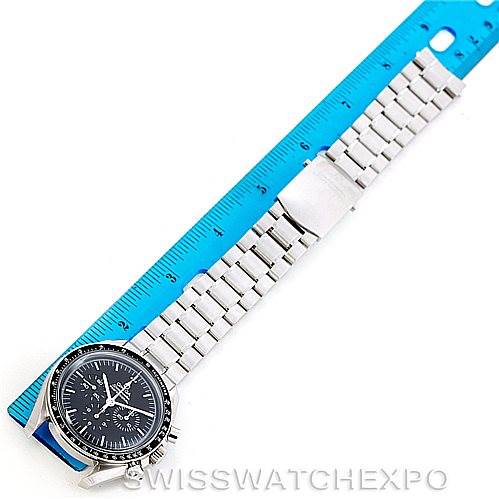 The image shows an Omega Speedmaster 3570.50.00 Men
s Stainless Steel Black Dial 3570.50.00 Men
s Stainless Steel Black Dial watch laid flat, face-up, next to a blue ruler.