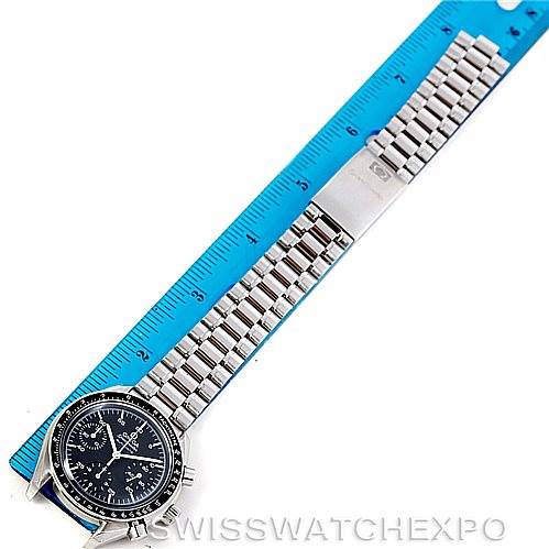 The Omega Speedmaster 3510.50.00 Men
s Stainless Steel Black Dial 3510.50.00 Men
s Stainless Steel Black Dial watch is shown lying flat with a blue ruler for scale, displaying the face and full metal bracelet.