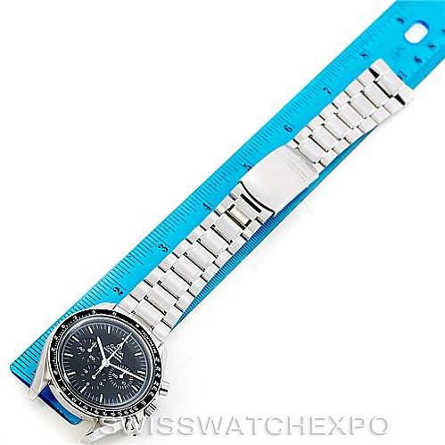 The image shows an Omega Speedmaster 3560.50.00 Men
s Stainless Steel Black Dial 3560.50.00 Men
s Stainless Steel Black Dial watch laid flat next to a blue ruler, displaying its face and full metal band.