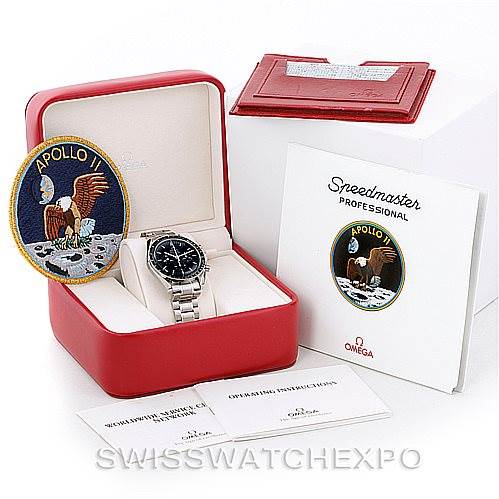 The image shows the Omega Speedmaster 3560.50.00 Men
s Stainless Steel Black Dial 3560.50.00 Men
s Stainless Steel Black Dial watch in its case, along with an Apollo 11 patch and accompanying booklets.