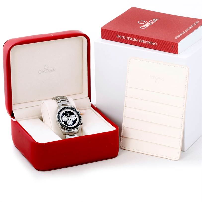 The Omega Speedmaster 3507.51.00 Men
s Stainless Steel Black Dial 3507.51.00 Men
s Stainless Steel Black Dial watch is displayed in an open red and white box, accompanied by an instruction manual and a cardholder.