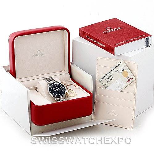 The Omega Speedmaster 3572.50.00 Men
s Stainless Steel Black Dial 3572.50.00 Men
s Stainless Steel Black Dial watch is shown in its open box with accompanying warranty cards and a manual in the background.