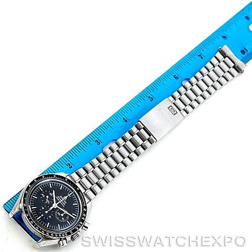 The image shows an Omega Speedmaster 3572.50.00 Men
s Stainless Steel Black Dial 3572.50.00 Men
s Stainless Steel Black Dial watch laid flat next to a ruler, displaying the face and bracelet.