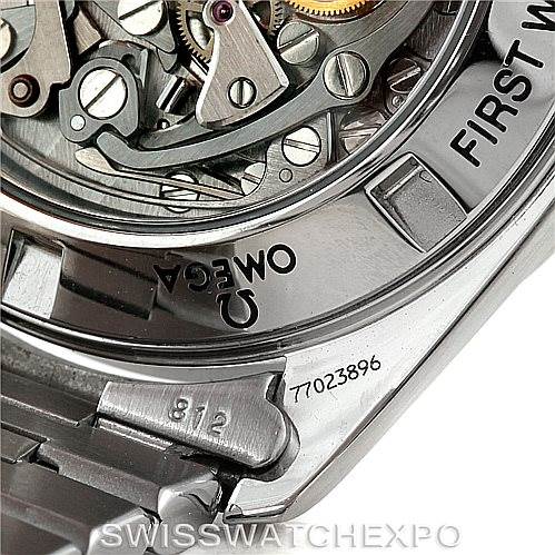 The image shows a close-up of the movement and caseback of an Omega Speedmaster 3572.50.00 Men
s Stainless Steel Black Dial 3572.50.00 Men
s Stainless Steel Black Dial watch, focusing on the intricate gears and inscriptions.