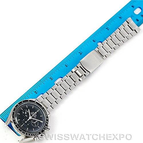 The Omega Speedmaster 3570.50.00 Men's Stainless Steel Black Dial 3570.50.00 Men's Stainless Steel Black Dial watch is shown laid flat with a blue ruler for scale, displaying the bracelet and face from a top-down angle.