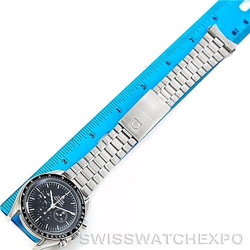 The image shows an Omega Speedmaster 3590.50.00 Men's Stainless Steel Black Dial 3590.50.00 Men's Stainless Steel Black Dial watch placed flat with its bracelet extended against a blue ruler for scale.