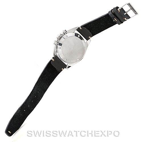 The image shows an overhead view of the backside of an Omega Speedmaster Men
s Stainless Steel Black Dial Men
s Stainless Steel Black Dial watch with a black strap and silver buckle.