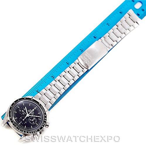 The Omega Speedmaster 3570.50.00 Men
s Stainless Steel Black Dial 3570.50.00 Men
s Stainless Steel Black Dial watch is shown from an overhead view, with its stainless steel bracelet spread out against a blue ruler.