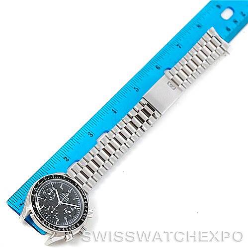The Omega Speedmaster 3510.50.00 Men
s Stainless Steel Black Dial 3510.50.00 Men
s Stainless Steel Black Dial watch is shown lying flat with its bracelet extended alongside a blue ruler.
