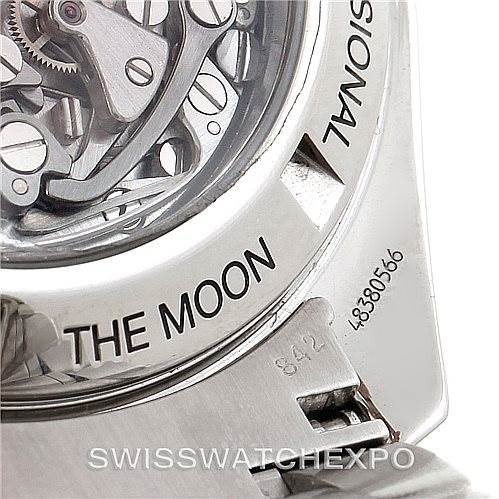 The image shows a close-up of the case back of an Omega Speedmaster 3572.50.00 Men
s Stainless Steel Black Dial 3572.50.00 Men
s Stainless Steel Black Dial, displaying parts of the movement and the "The Moon" engraving.