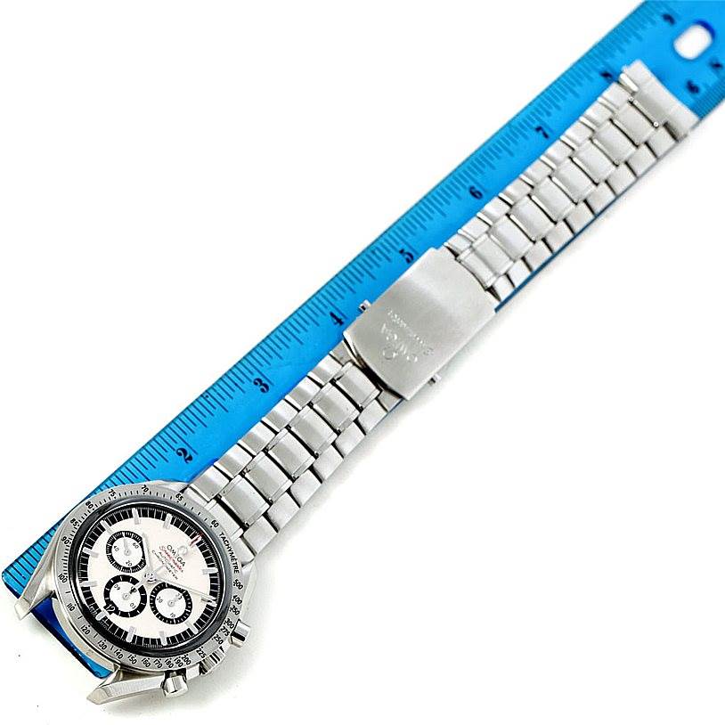 The Omega Speedmaster 3506.31.00 Men
s Stainless Steel Silver Dial 3506.31.00 Men
s Stainless Steel Silver Dial watch is shown from a top-down angle, displaying its face, bracelet, and clasp alongside a blue ruler.