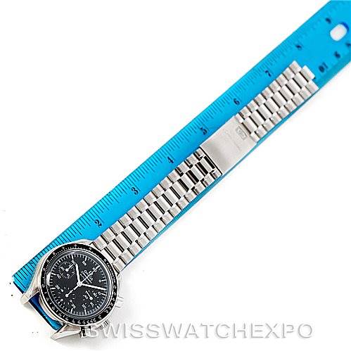 The image shows an Omega Speedmaster 3510.50.00 Men
s Stainless Steel Black Dial 3510.50.00 Men
s Stainless Steel Black Dial watch laid flat with its bracelet extended next to a blue ruler measuring its length.