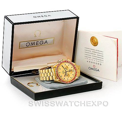 The Omega Speedmaster 145022 Men's Yellow Gold Champagne Dial 145022 Men's Yellow Gold Champagne Dial watch is shown at an angle in its open box, alongside its certification documents.