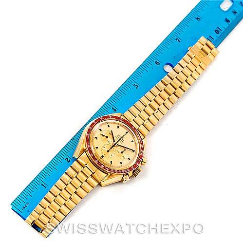 The image shows an Omega Speedmaster 145022 Men's Yellow Gold Champagne Dial 145022 Men's Yellow Gold Champagne Dial watch straight-on, with a gold bracelet and a ruler beside it for scale.