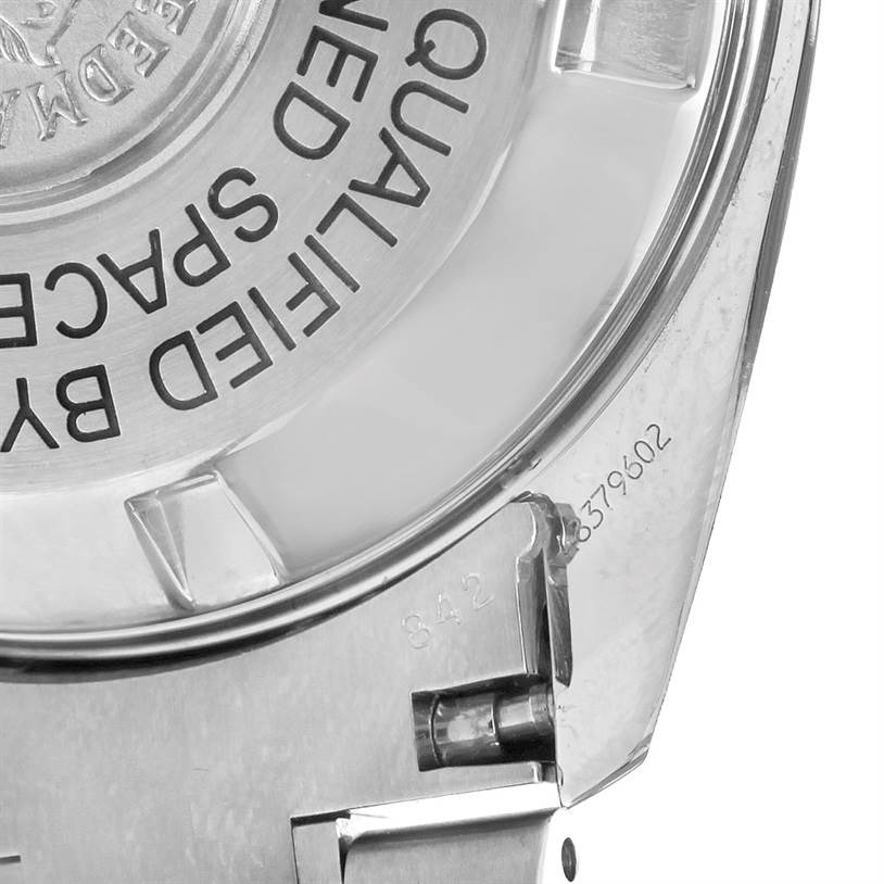 The image shows a close-up of the back case of the Omega Speedmaster 3597.21.00 Men
s Stainless Steel Black Dial 3597.21.00 Men
s Stainless Steel Black Dial watch, including part of the bracelet.