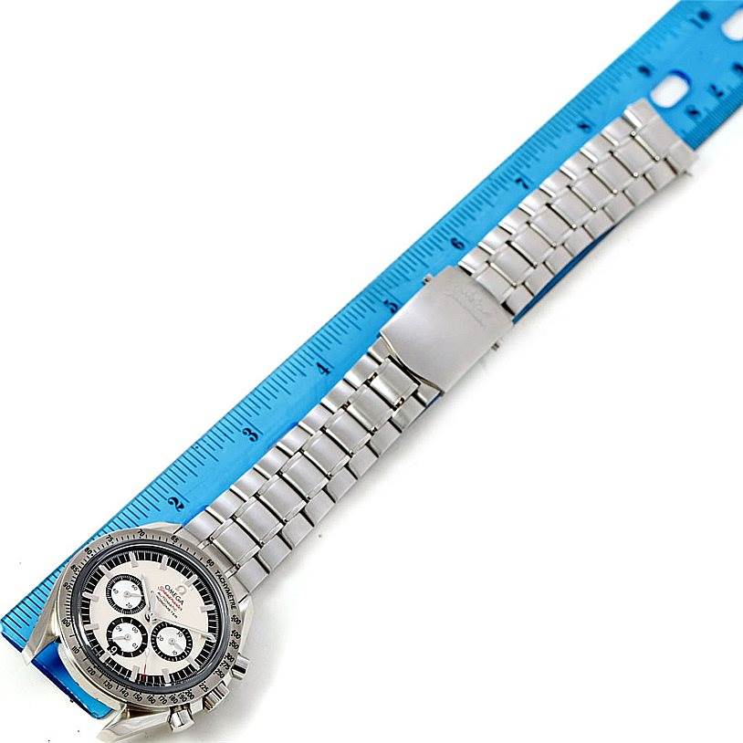 This image shows an Omega Speedmaster 3506.31.00 Men
s Stainless Steel Silver Dial 3506.31.00 Men
s Stainless Steel Silver Dial watch laid flat with a blue ruler measuring its band length.