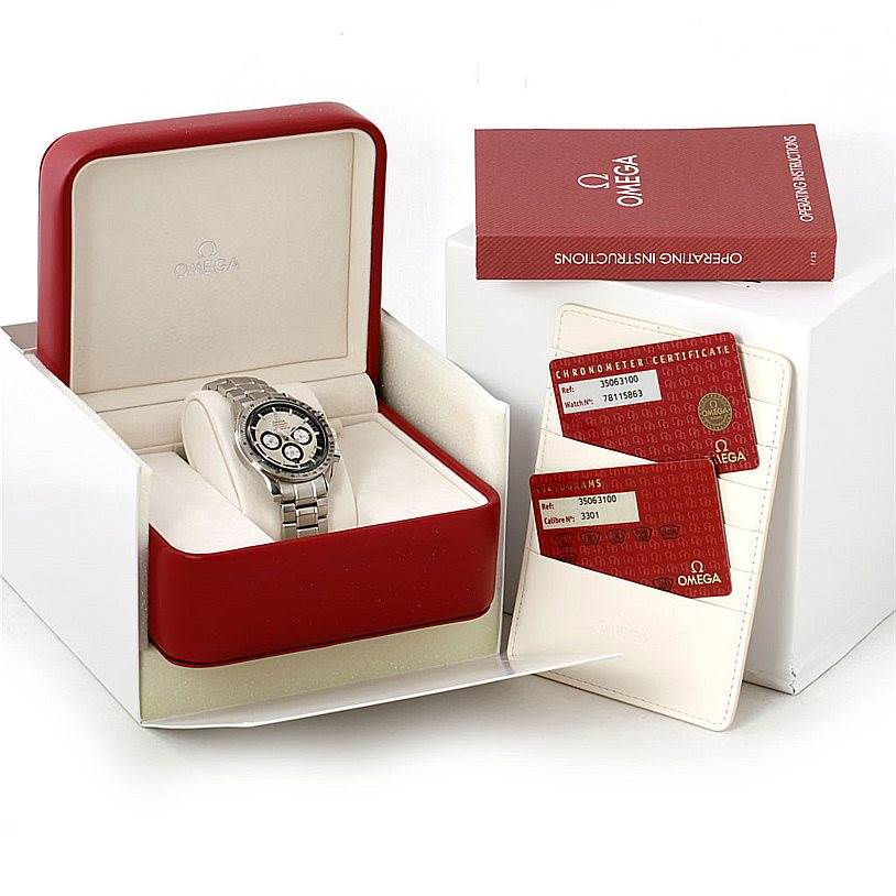 The Omega Speedmaster 3506.31.00 Men
s Stainless Steel Silver Dial 3506.31.00 Men
s Stainless Steel Silver Dial watch is shown in its open display box along with a warranty card holder and an operating instructions booklet.