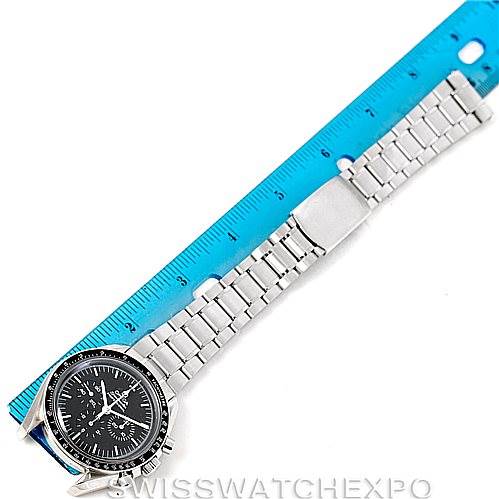 This image shows an Omega Speedmaster 3570.50.00 Men
s Stainless Steel Black Dial 3570.50.00 Men
s Stainless Steel Black Dial watch laid flat next to a blue ruler, highlighting the full watchband and face.