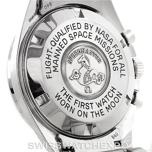 The image shows the back side of an Omega Speedmaster 3570.50.00 Men
s Stainless Steel Black Dial 3570.50.00 Men
s Stainless Steel Black Dial watch, highlighting its engraved details and the crown.