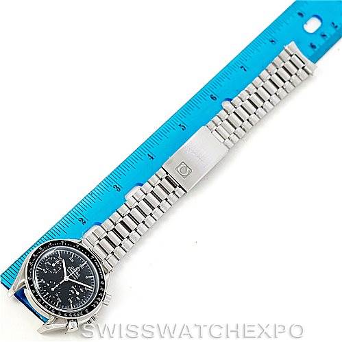 The image shows an Omega Speedmaster 3510.50.00 Men
s Stainless Steel Black Dial 3510.50.00 Men
s Stainless Steel Black Dial model watch laid flat with its bracelet extended alongside a blue ruler.