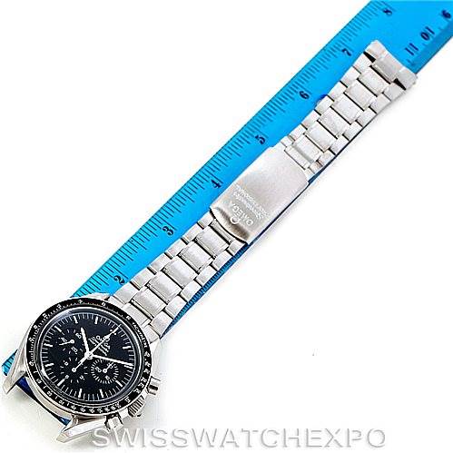 The image shows an Omega Speedmaster 3570.50.00 Men
s Stainless Steel Black Dial 3570.50.00 Men
s Stainless Steel Black Dial watch face and metal bracelet, laid flat next to a blue ruler for size reference.