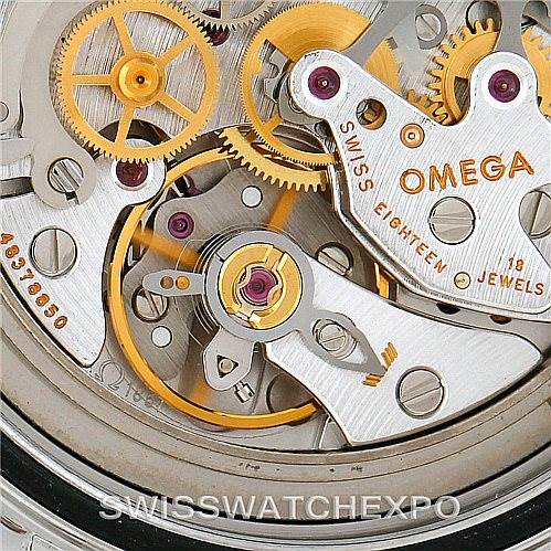 The image shows a close-up of the Omega Speedmaster 3570.50.00 Men
s Stainless Steel Black Dial 3570.50.00 Men
s Stainless Steel Black Dial watch movement, highlighting gears and mechanical parts.