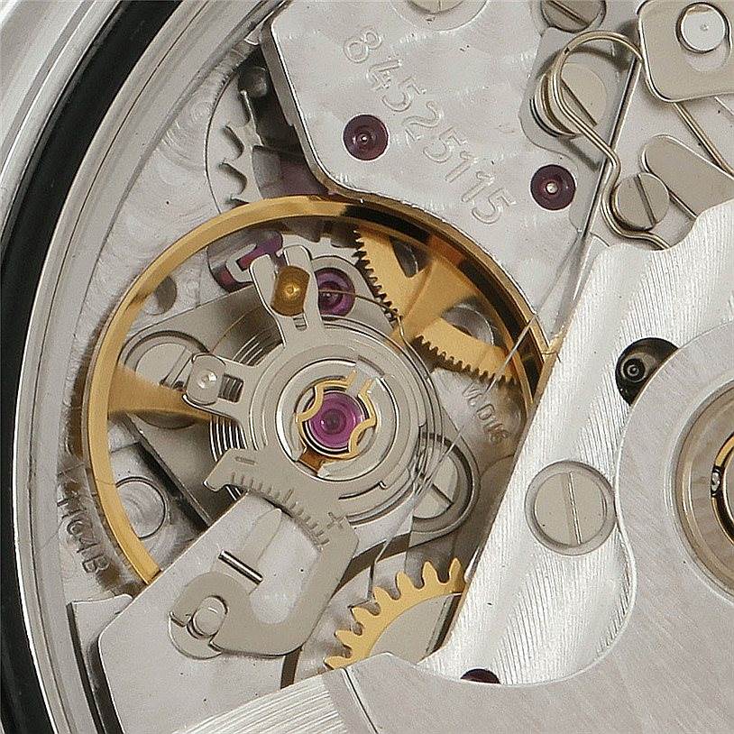 This close-up image of an Omega Speedmaster 3210.51.00 Men
s Stainless Steel Black Dial 3210.51.00 Men
s Stainless Steel Black Dial watch reveals the intricate details of its internal mechanical movement.