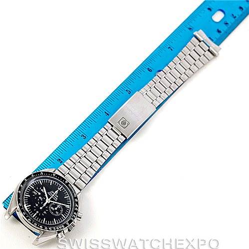 This image shows an Omega Speedmaster Men
s Stainless Steel Black Dial Men
s Stainless Steel Black Dial watch from a top-down angle, displaying the full length of the watch and measuring it against a blue ruler.