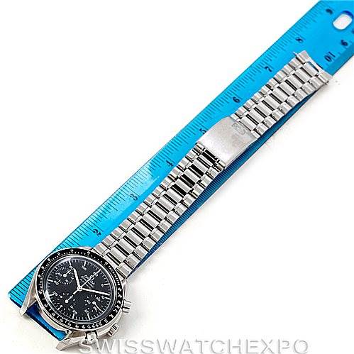 The Omega Speedmaster 3510.50.00 Men
s Stainless Steel Black Dial 3510.50.00 Men
s Stainless Steel Black Dial watch is shown from a top-down angle, including the dial, bezel, and full stainless steel bracelet next to a ruler for scale.