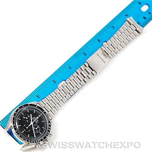 The image shows a top-down view of an Omega Speedmaster 3592.50.00 Men
s Stainless Steel Black Dial 3592.50.00 Men
s Stainless Steel Black Dial watch with a metal bracelet, placed alongside a blue ruler for scale.