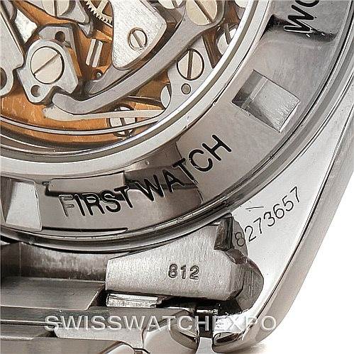 The image shows a close-up of the case back and movement of an Omega Speedmaster 3592.50.00 Men
s Stainless Steel Black Dial 3592.50.00 Men
s Stainless Steel Black Dial watch, highlighting engraved text and part of the serial number.