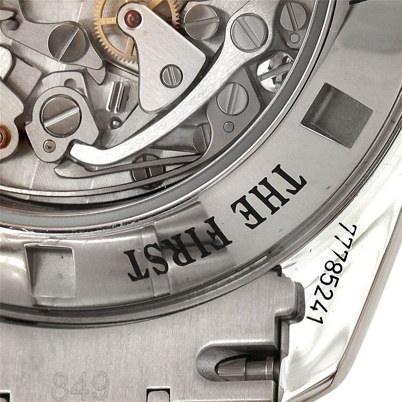 This image shows a close-up of the Omega Speedmaster 3576.50.00 Men
s Stainless Steel Black Dial 3576.50.00 Men
s Stainless Steel Black Dial
s open case back, revealing part of the movement and inscriptions.