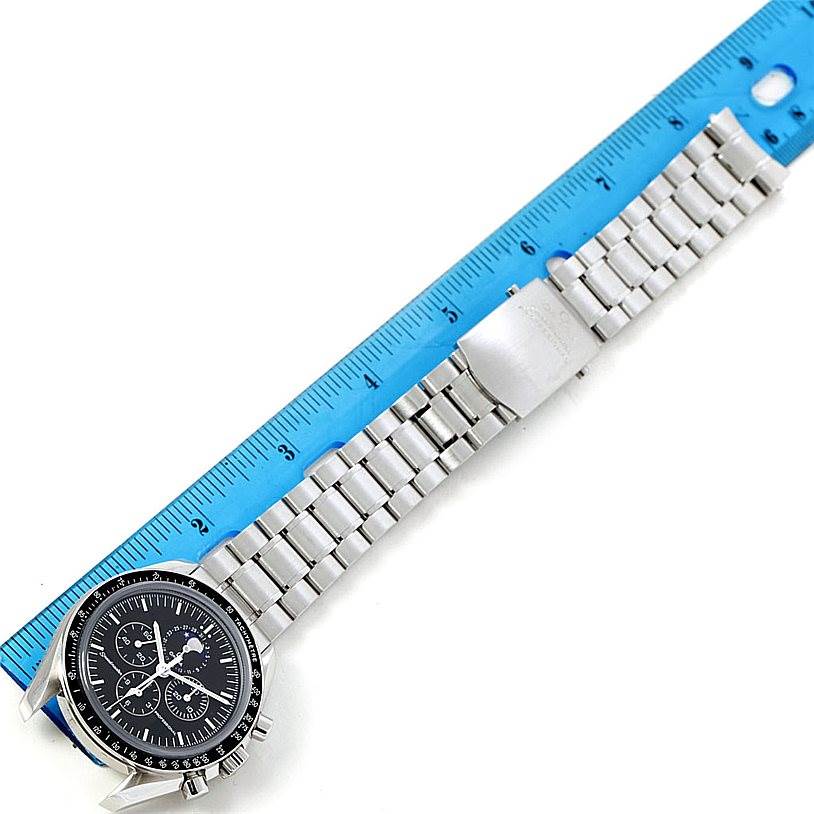 The image shows the front view of an Omega Speedmaster 3576.50.00 Men
s Stainless Steel Black Dial 3576.50.00 Men
s Stainless Steel Black Dial watch placed next to a blue ruler for measurement.