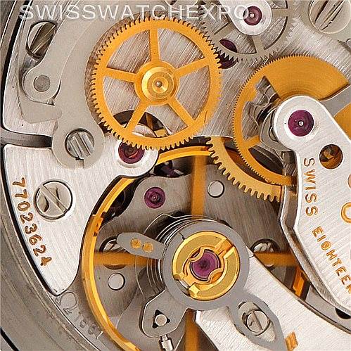 The image shows a close-up of the movement mechanism inside an Omega Speedmaster 3570.50.00 Men
s Stainless Steel Black Dial 3570.50.00 Men
s Stainless Steel Black Dial watch, highlighting gears and screws.