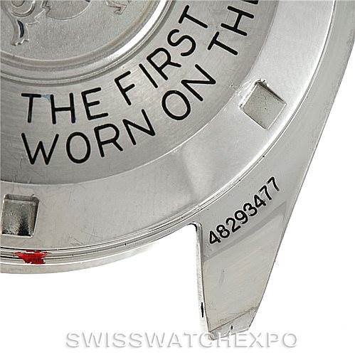 The image shows a close-up of the back case of an Omega Speedmaster Men
s Stainless Steel Black Dial Men
s Stainless Steel Black Dial watch, highlighting the engraved text and serial number.