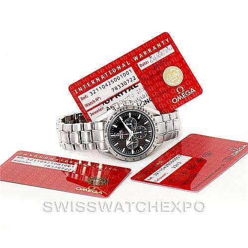The image shows an Omega Speedmaster 321.10.42.50.01.001 Men
s Stainless Steel Black Dial 321.10.42.50.01.001 Men
s Stainless Steel Black Dial watch with a stainless steel bracelet, positioned alongside international warranty cards.