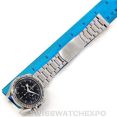 The Omega Speedmaster 3594.50.00 Men
s Stainless Steel Black Dial 3594.50.00 Men
s Stainless Steel Black Dial watch is shown from a top-down angle, highlighting its face, bracelet, and clasp next to a blue ruler.