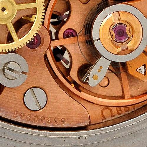 This close-up image shows the intricate mechanical movement of an Omega Speedmaster Men
s Stainless Steel Black Dial Men
s Stainless Steel Black Dial watch, highlighting the gears and inner workings.