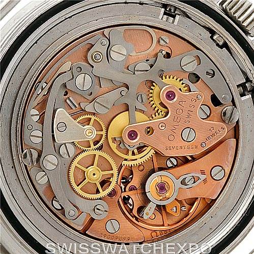 The image shows a close-up of the intricate mechanical movement of an Omega Speedmaster Men
s Stainless Steel Black Dial Men
s Stainless Steel Black Dial watch.