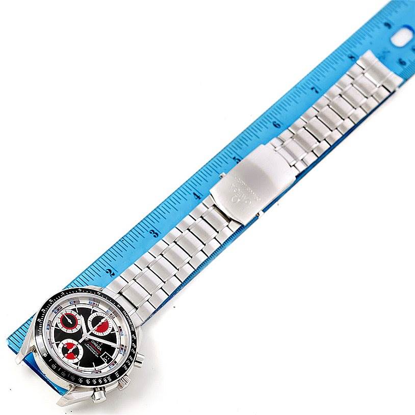 The image shows an Omega Speedmaster 3210.52.00 Men
s Stainless Steel Black Dial 3210.52.00 Men
s Stainless Steel Black Dial watch horizontally placed beside a ruler, highlighting the watch
s face and metal bracelet.