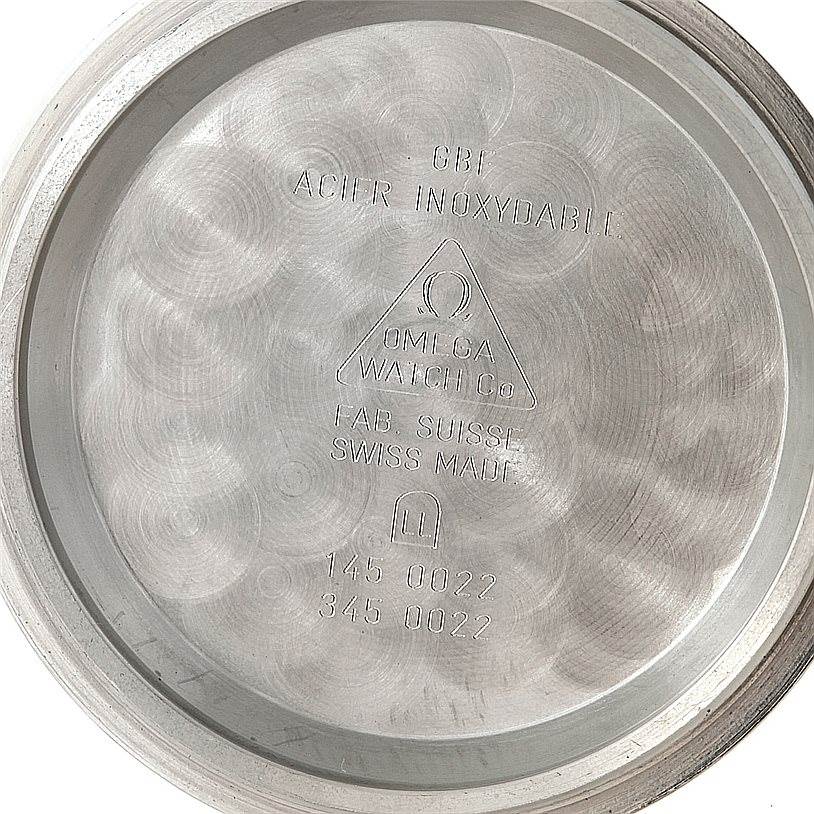 The image shows the inside case back of an Omega Speedmaster 48365704 Men
s Stainless Steel Black Dial 48365704 Men
s Stainless Steel Black Dial watch, featuring branding and model information.