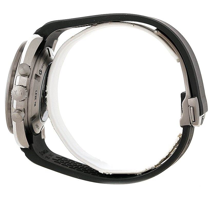 This side view of the Omega Speedmaster 321.92.44.52.01.001 Men
s Titanium Black Dial 321.92.44.52.01.001 Men
s Titanium Black Dial watch shows the case, pushers, and black strap with clasp.
