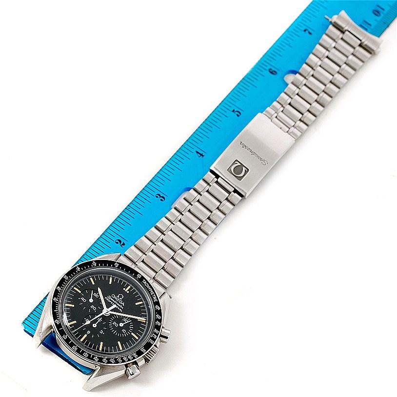 The image shows an Omega Speedmaster 3590.50.00 Men
s Stainless Steel Black Dial 3590.50.00 Men
s Stainless Steel Black Dial watch at a roughly 45-degree angle, highlighting its face, bracelet, and clasp against a ruler.