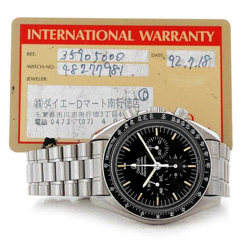 The image shows the front view of the Omega Speedmaster 3590.50.00 Men
s Stainless Steel Black Dial 3590.50.00 Men
s Stainless Steel Black Dial watch along with its international warranty card in the background.
