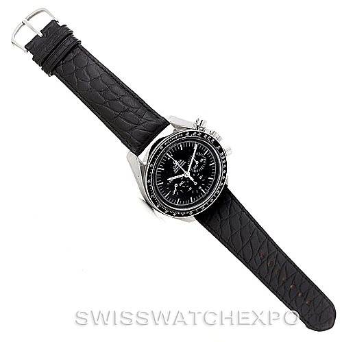 The image shows an overhead view of an Omega Speedmaster Men
s Stainless Steel Black Dial Men
s Stainless Steel Black Dial watch with a black leather strap and a black dial.
