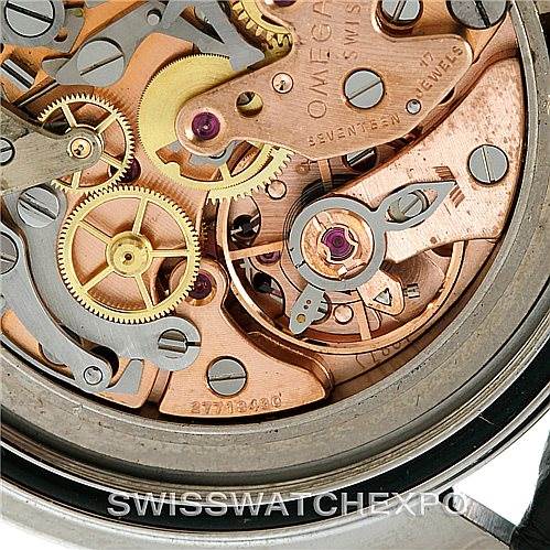 The image shows a close-up of the intricate movement and gears of an Omega Speedmaster Men
s Stainless Steel Black Dial Men
s Stainless Steel Black Dial watch.