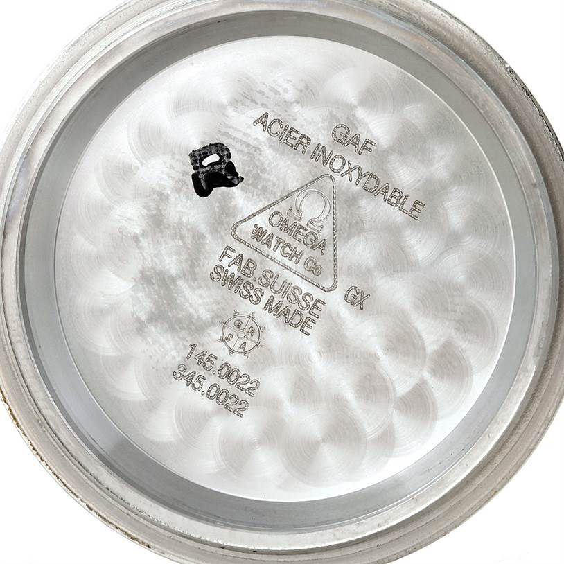 The image shows the inside of the case back of an Omega Speedmaster Men
s Stainless Steel Black Dial Men
s Stainless Steel Black Dial watch, with inscriptions indicating its model and material.