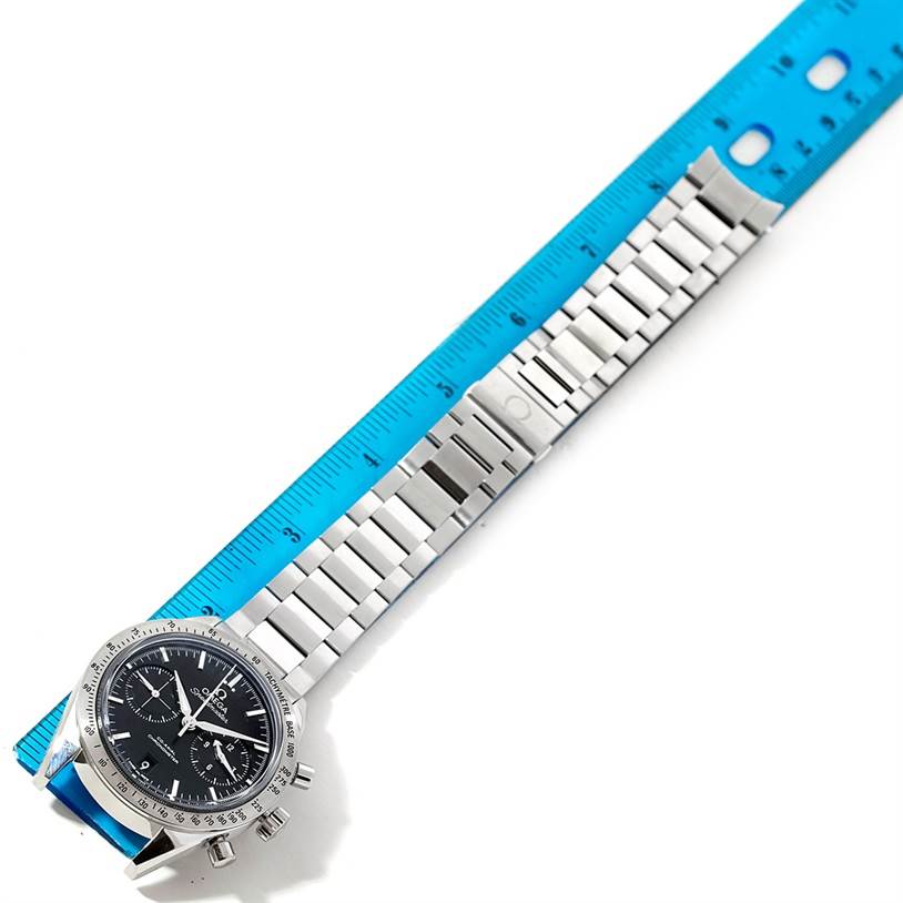The Omega Speedmaster 331.10.42.51.01.001 Men
s Stainless Steel Black Dial 331.10.42.51.01.001 Men
s Stainless Steel Black Dial watch is shown lying flat with its stainless steel bracelet alongside a blue ruler.