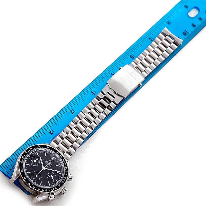 The image shows an Omega Speedmaster 3539.50.00 Men
s Stainless Steel Black Dial 3539.50.00 Men
s Stainless Steel Black Dial watch placed alongside a blue ruler, displaying the full watch band and face.